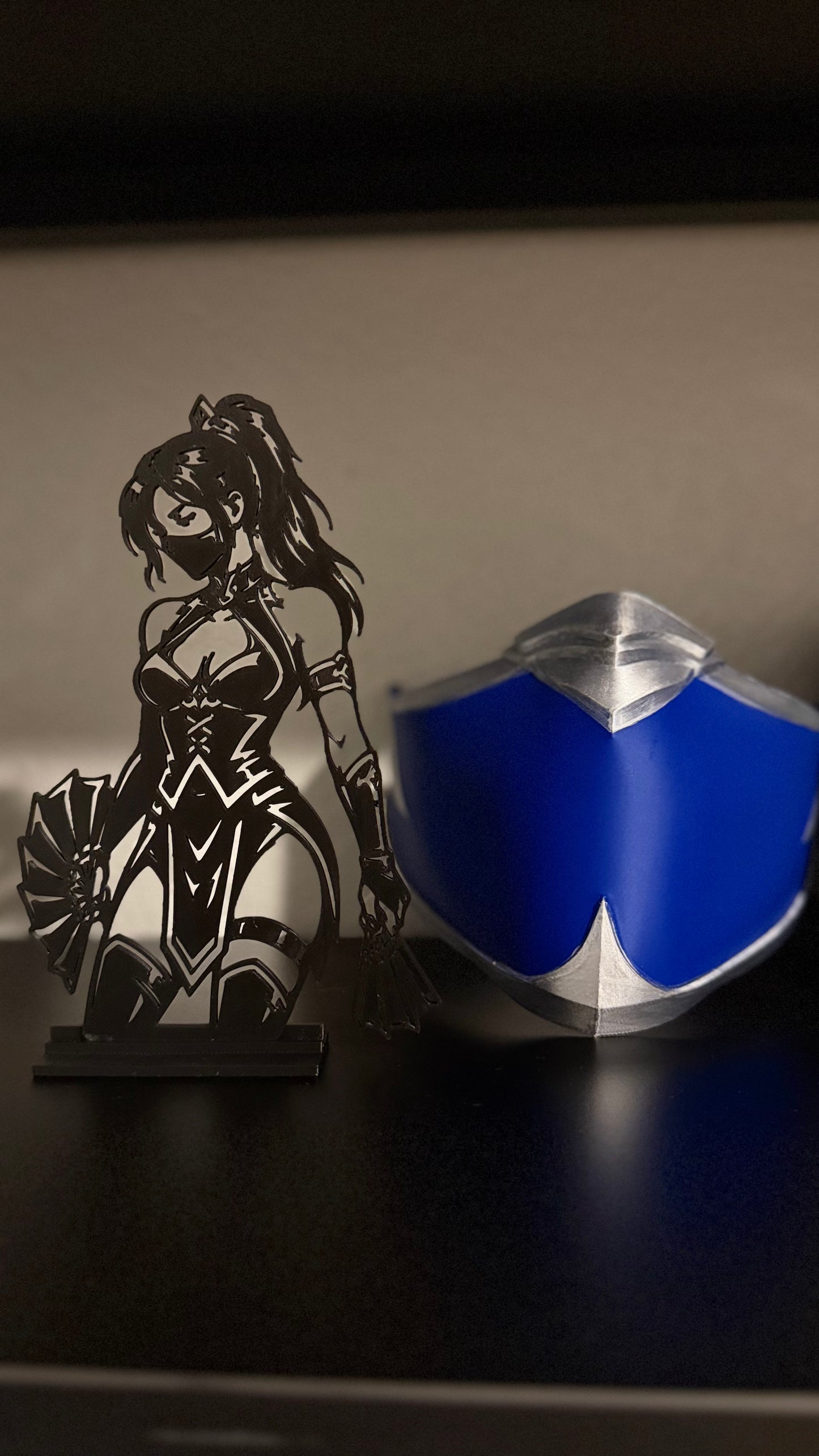 Kitana silhouette shelf display with war fans, matte black linework detail